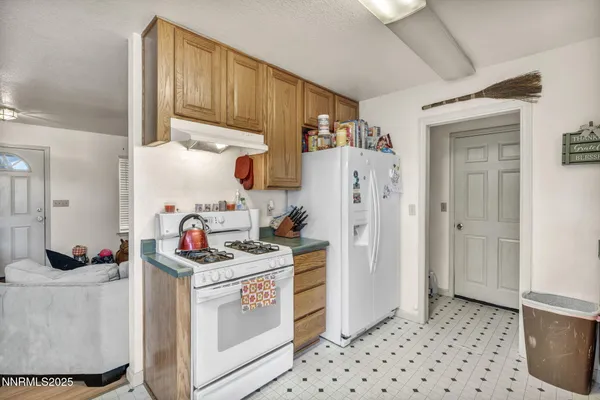 a kitchen with stainless steel appliances a stove a refrigerator and cabinets