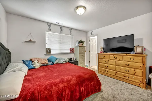 a bed room with a bed and flat screen tv