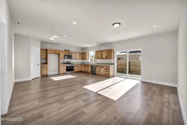 a view of kitchen with cabinets and wooden floor