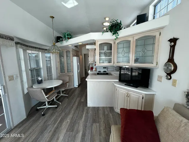 a kitchen with stainless steel appliances a stove a table and chairs