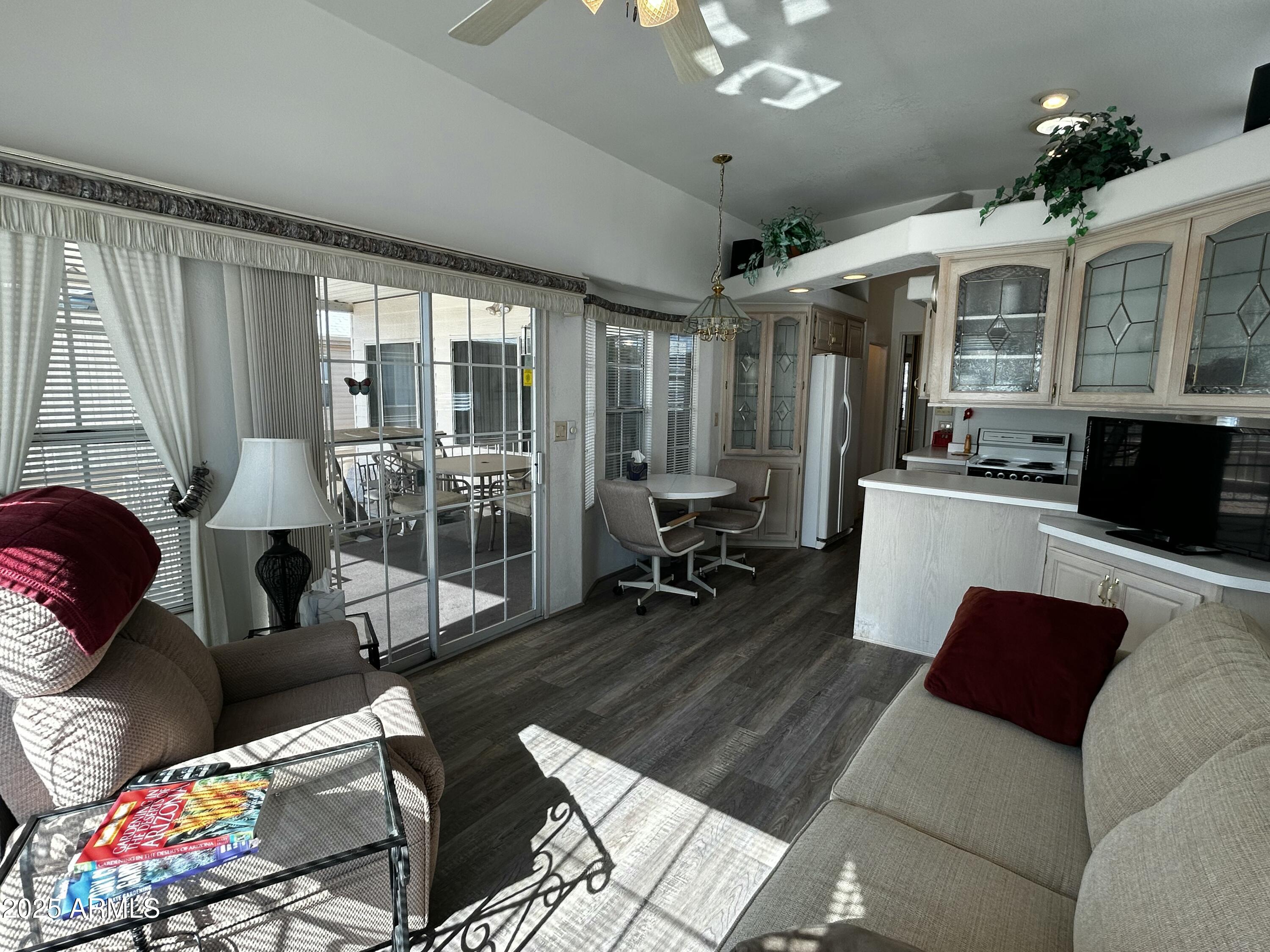 111 South Greenfield Road, Unit 596 Mesa, AZ 85206 - Photo 12 of 26 a living room with furniture and a large window