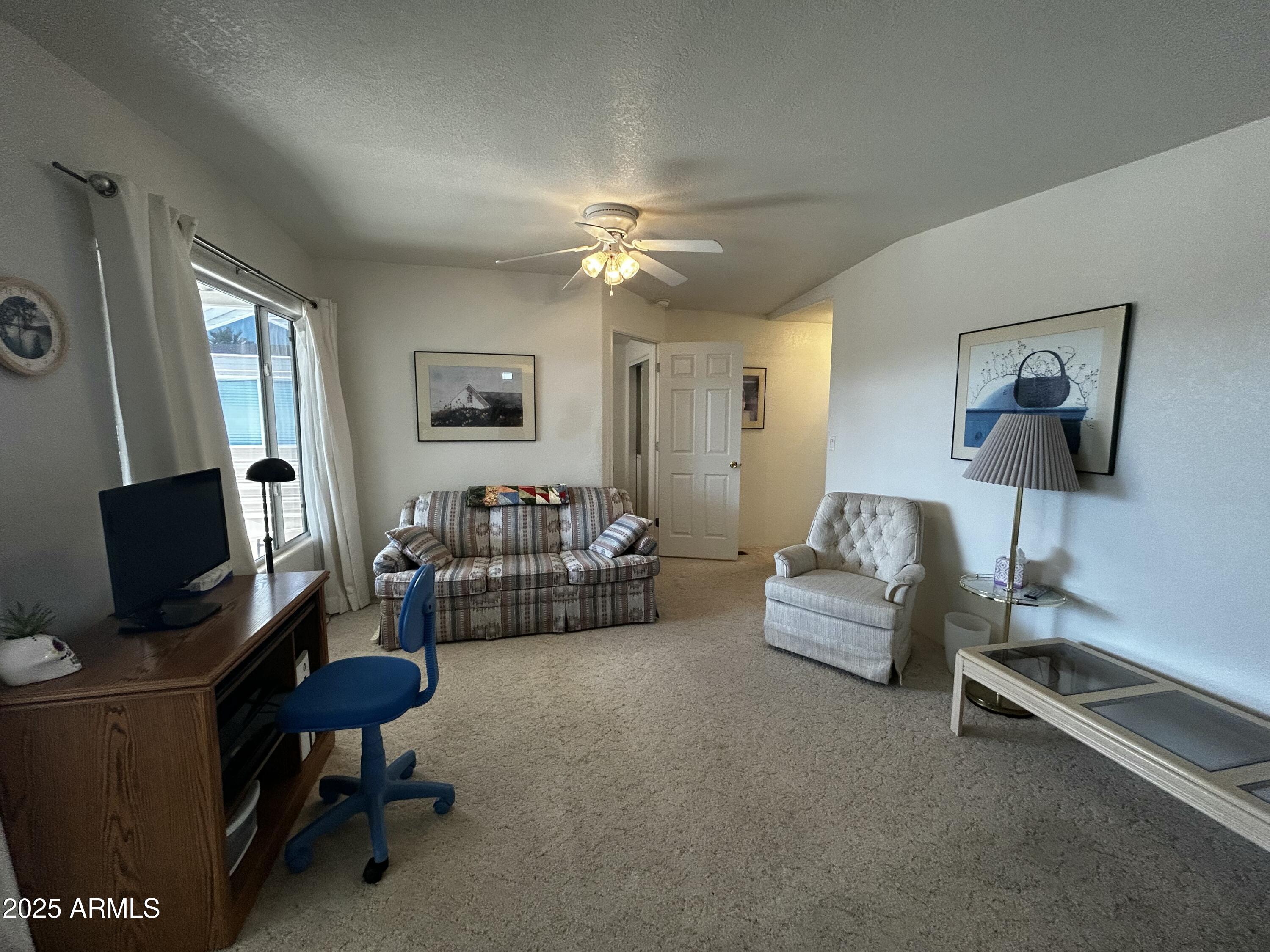 111 South Greenfield Road, Unit 596 Mesa, AZ 85206 - Photo 17 of 26 a living room with furniture and a flat screen tv