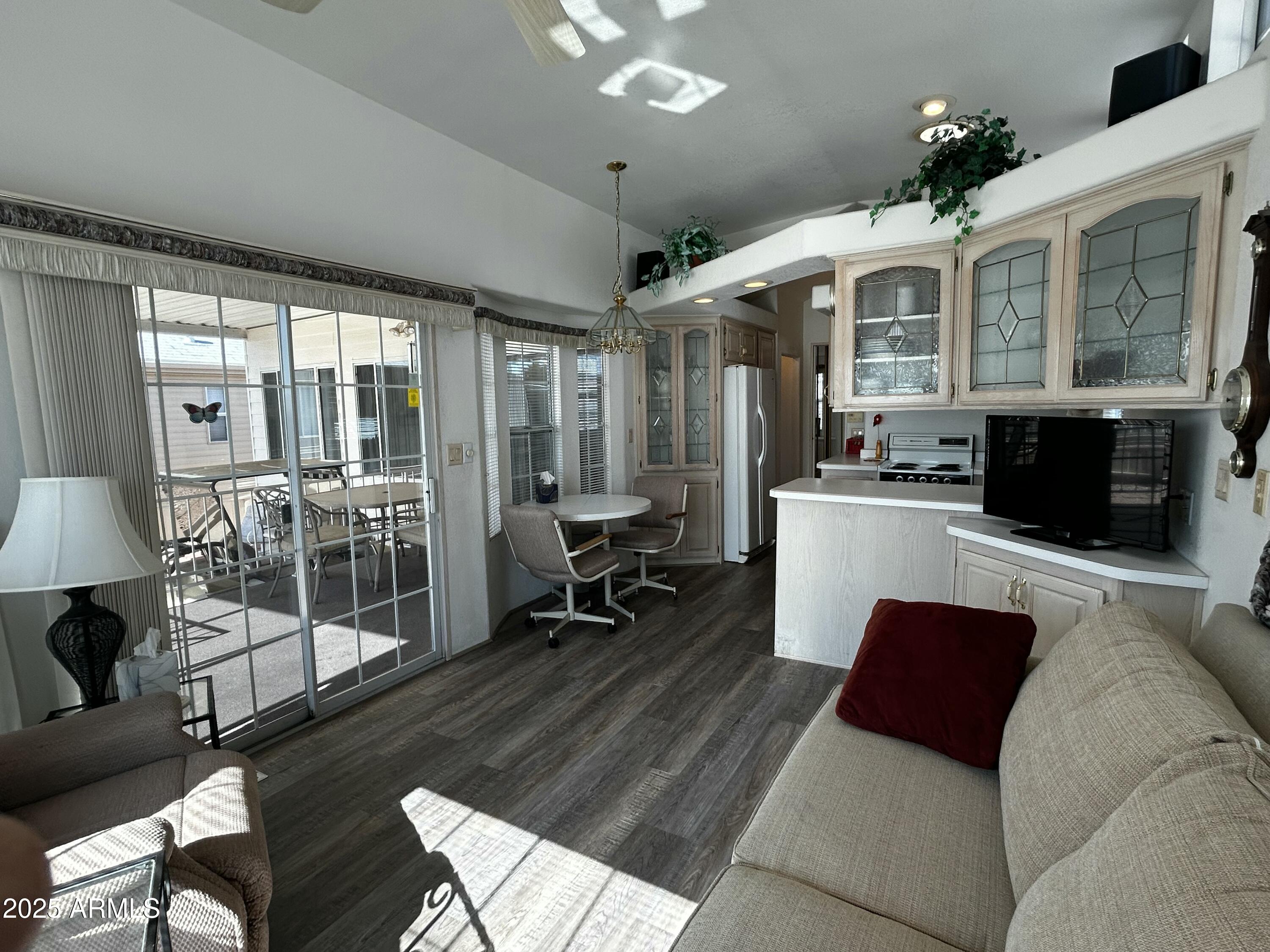 111 South Greenfield Road, Unit 596 Mesa, AZ 85206 - Photo 2 of 26 a living room with furniture a flat screen tv and a large window