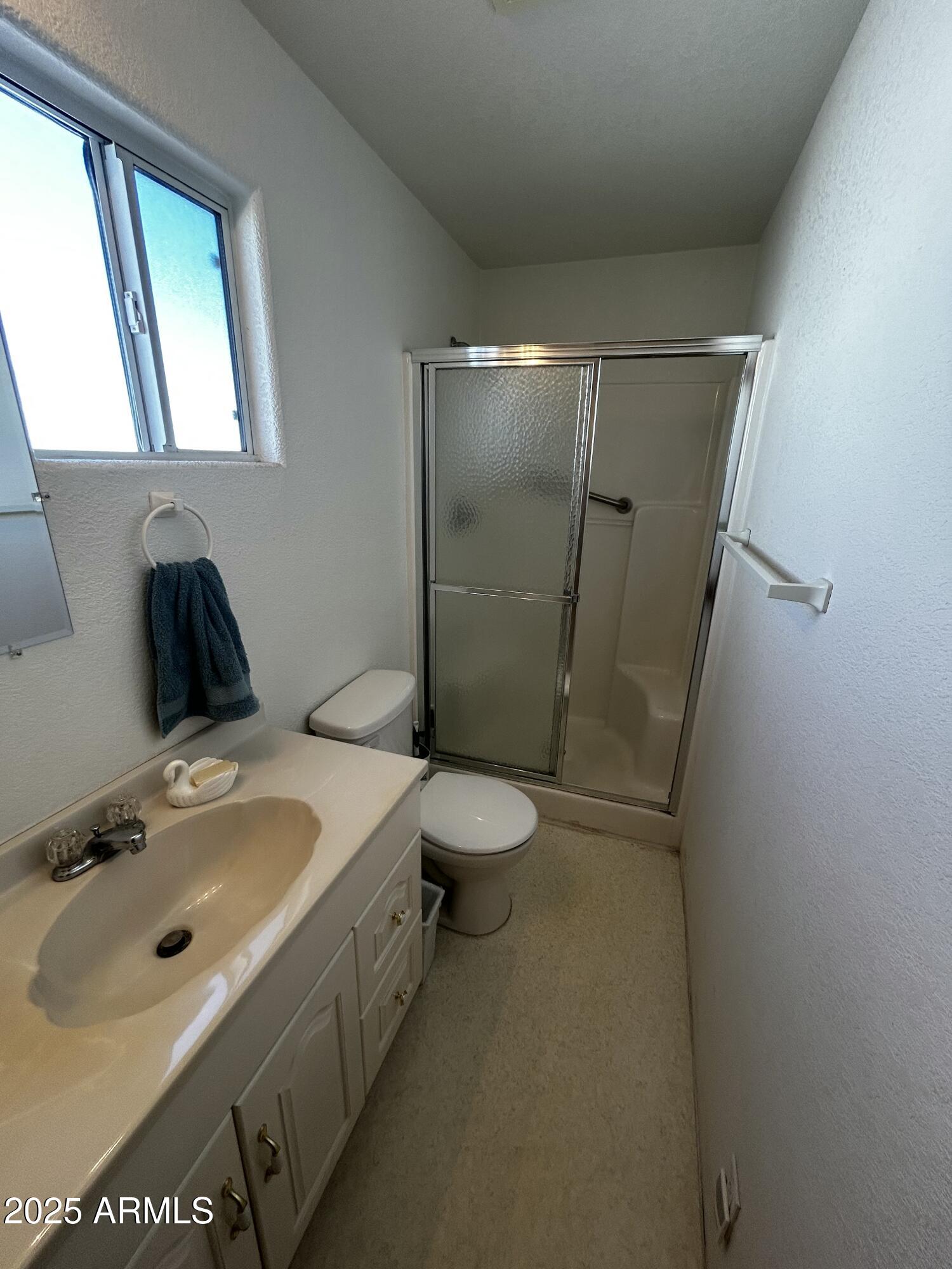 111 South Greenfield Road, Unit 596 Mesa, AZ 85206 - Photo 21 of 26 a bathroom with a sink toilet and shower