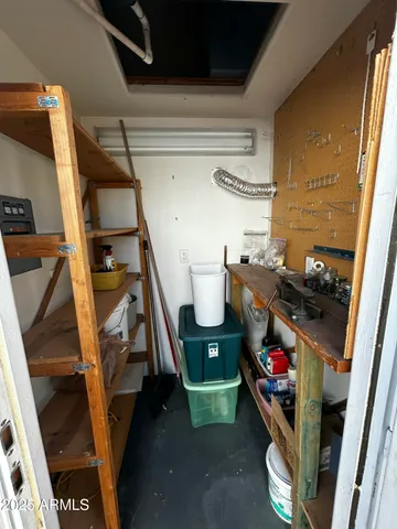 a storage room with water heater and racks