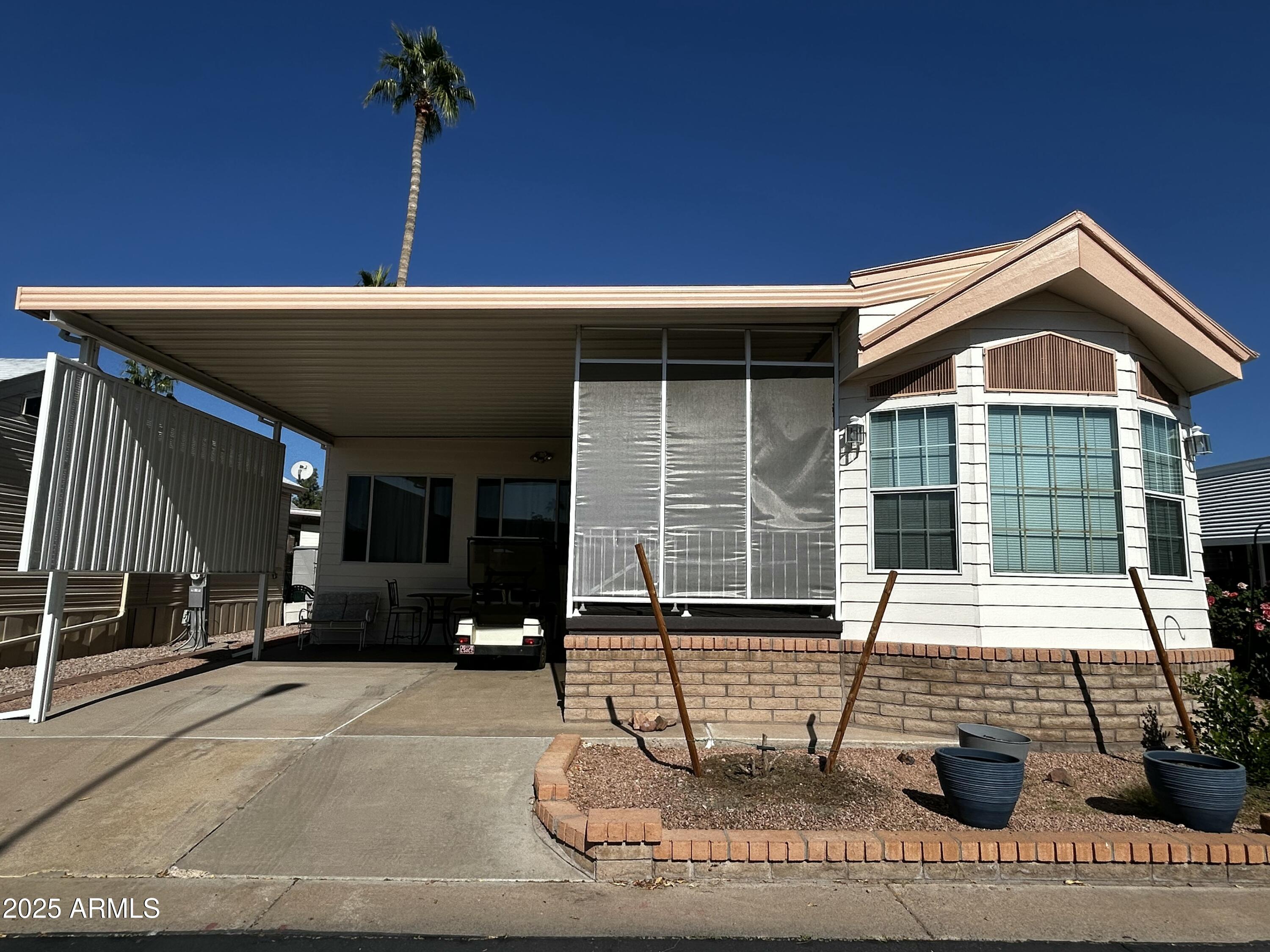 111 South Greenfield Road, Unit 596 Mesa, AZ 85206 - Photo 4 of 26 a front view of a house with garden