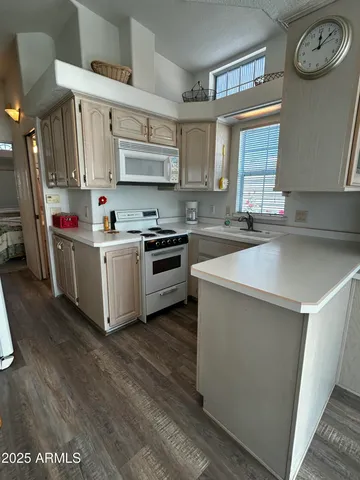a kitchen with a stove top oven sink and cabinets