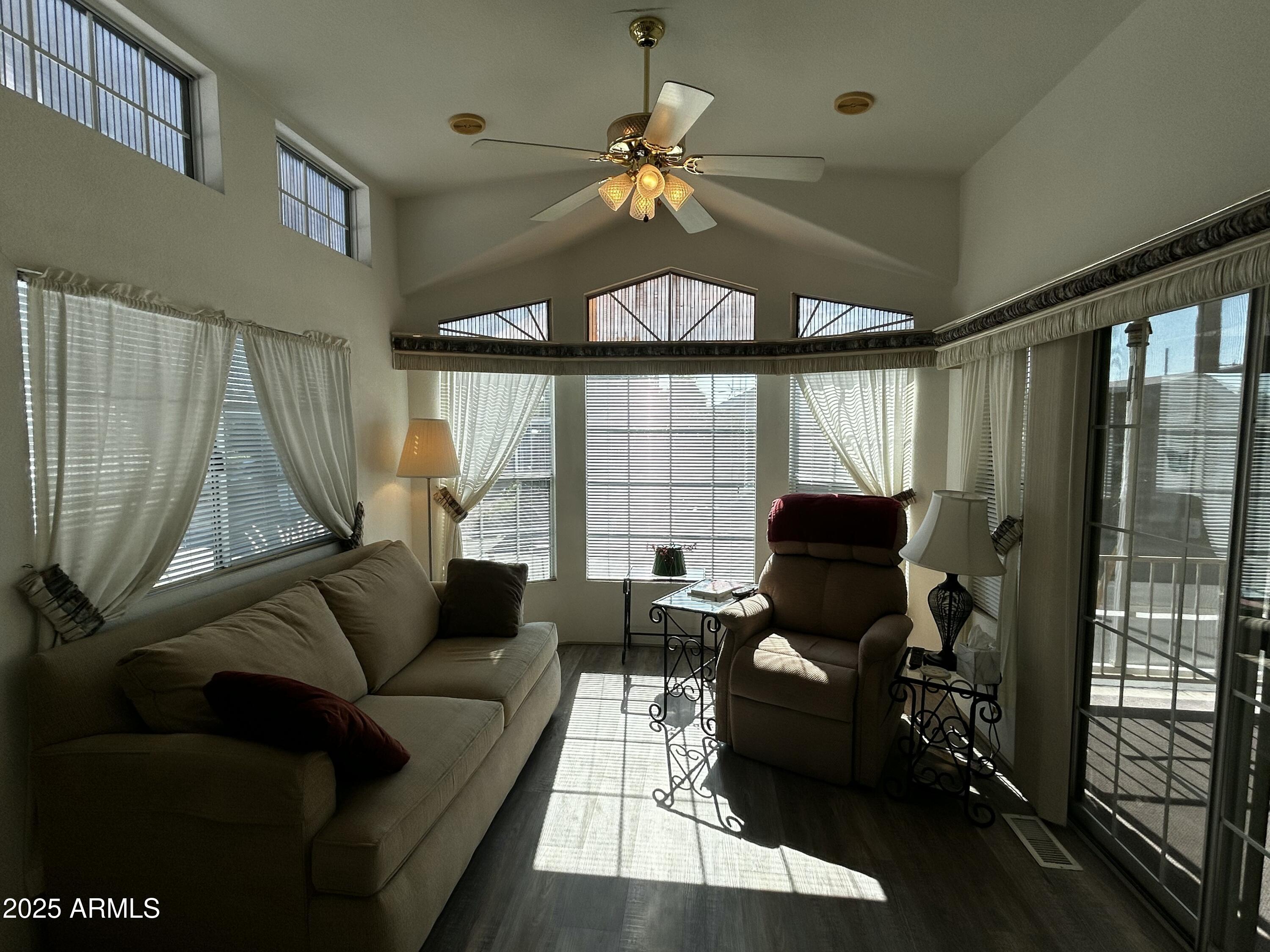 111 South Greenfield Road, Unit 596 Mesa, AZ 85206 - Photo 10 of 26 a living room with furniture and a large window