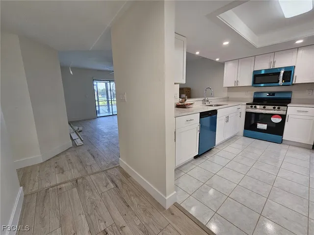 a kitchen with granite countertop a stove top oven sink and cabinets