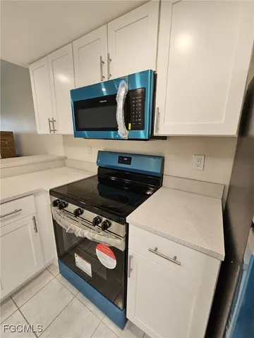 a kitchen with a stove and a microwave
