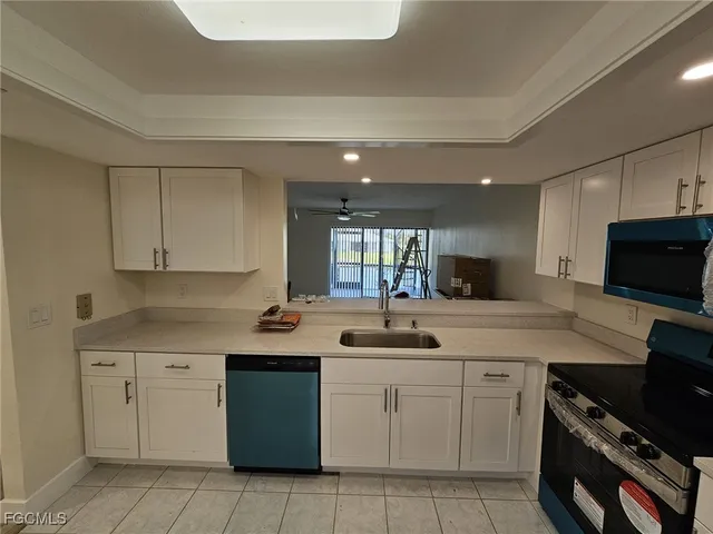 a kitchen with a sink stove and cabinets