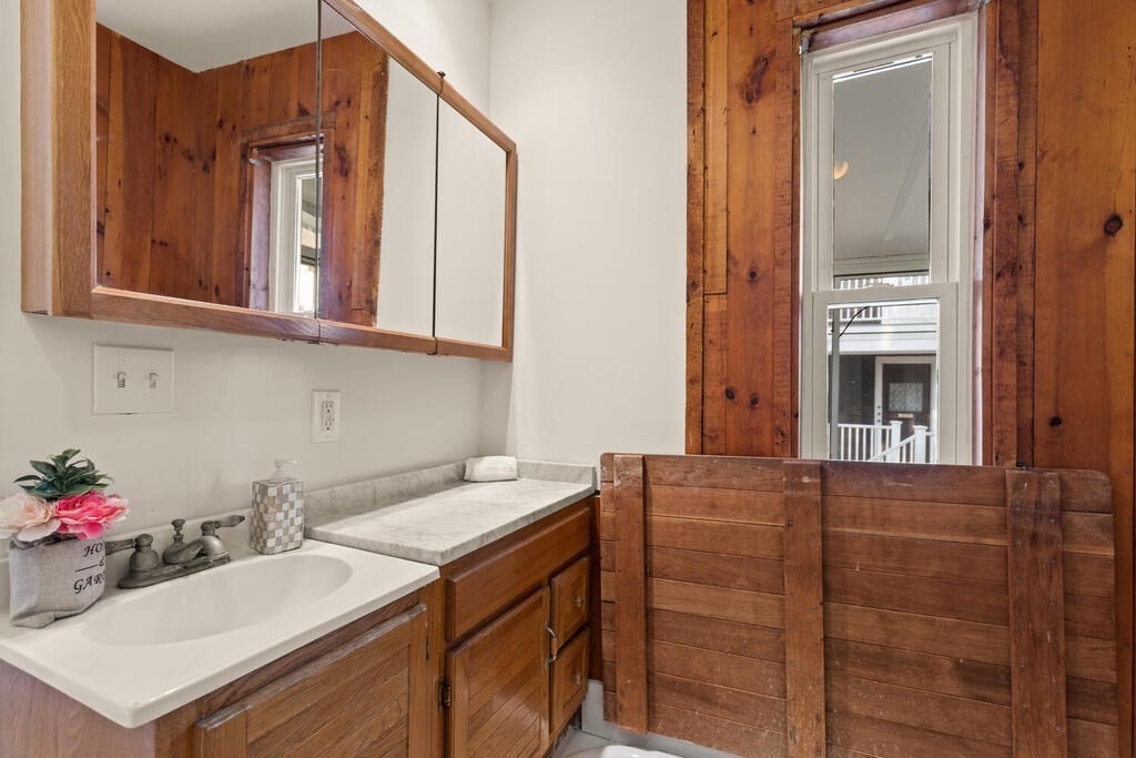 1 Shore Avenue Salem, MA 01970 - Photo 11 of 42 a bathroom with a sink vanity and a mirror