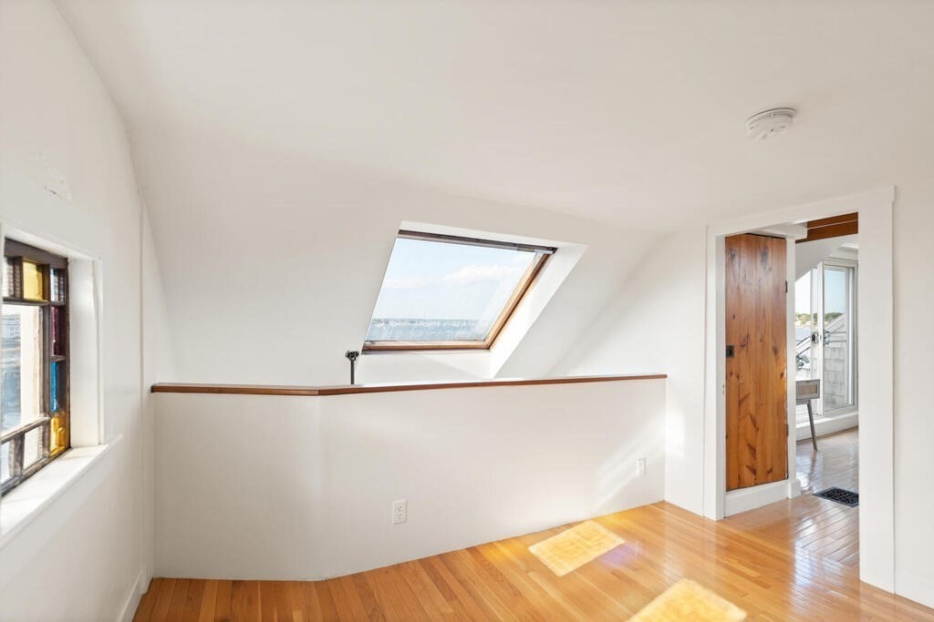 1 Shore Avenue Salem, MA 01970 - Photo 28 of 42 a view of a bedroom with wooden floor and a bathroom