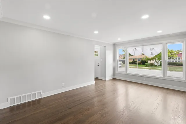 a view of room with window and wooden floor