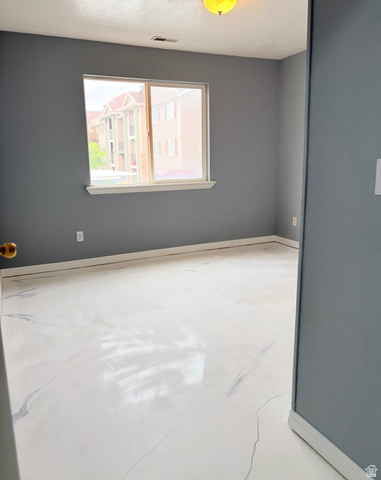 8116 North Ridge Loop West, Unit 8 Eagle Mountain, UT 84005 - Photo 17 of 23 Spare room featuring concrete floors and a textured ceiling