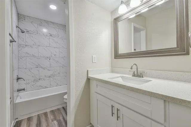 a bathroom with a granite countertop sink mirror and a