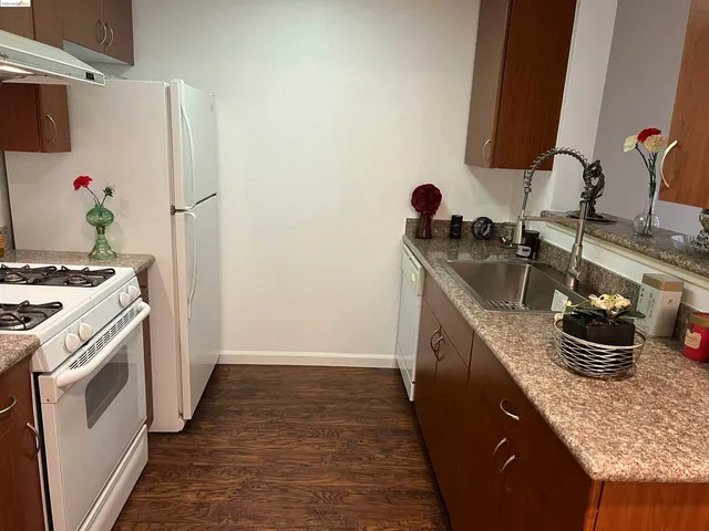 a kitchen with a sink and a stove top oven