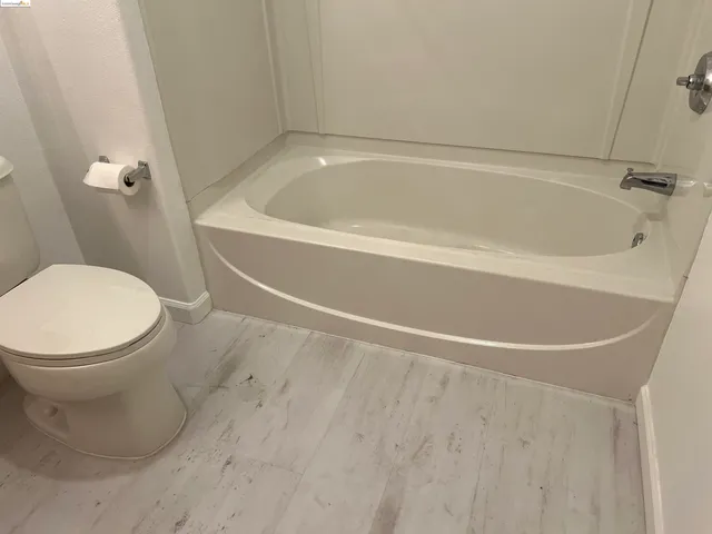 a bathroom with a toilet and a bathtub