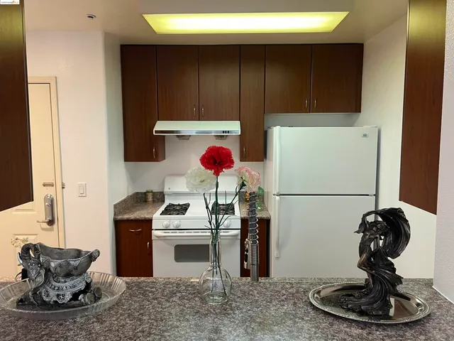 a kitchen with a refrigerator and a stove