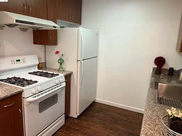 a kitchen with a stove and a refrigerator