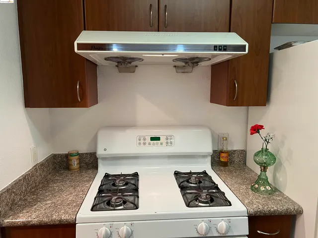 a kitchen with a stove and cabinets