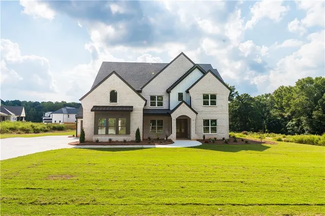 a front view of a house with swimming pool having outdoor seating