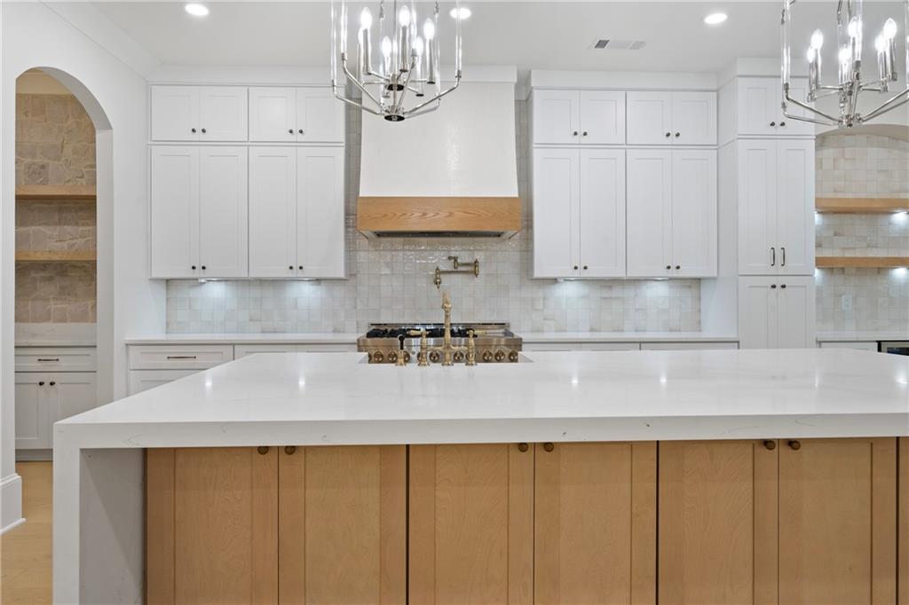3287 Hall Road Dacula, GA 30019 - Photo 18 of 74 a kitchen with stainless steel appliances granite countertop a sink a stove and a white cabinets