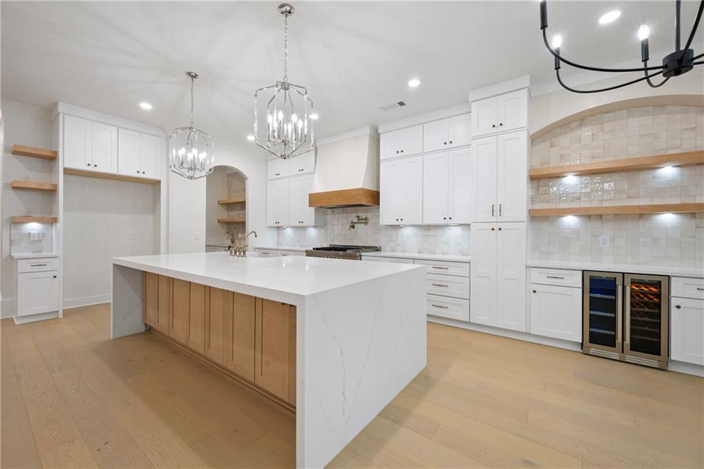 3287 Hall Road Dacula, GA 30019 - Photo 19 of 74 a kitchen with kitchen island granite countertop a sink cabinets and stainless steel appliances