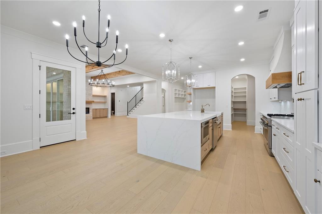 3287 Hall Road Dacula, GA 30019 - Photo 21 of 74 a large kitchen with stainless steel appliances a large counter top a large counter space and cabinets