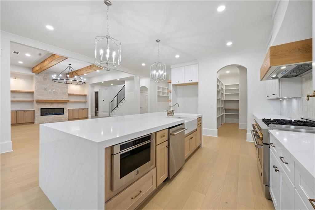 3287 Hall Road Dacula, GA 30019 - Photo 23 of 74 a large kitchen with stainless steel appliances granite countertop a stove and a sink