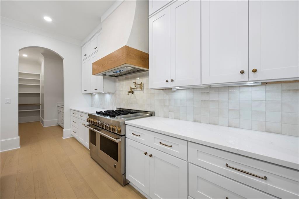 3287 Hall Road Dacula, GA 30019 - Photo 24 of 74 a kitchen with stainless steel appliances white cabinets and a stove