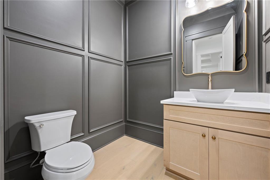 3287 Hall Road Dacula, GA 30019 - Photo 28 of 74 a bathroom with a toilet a sink and a mirror