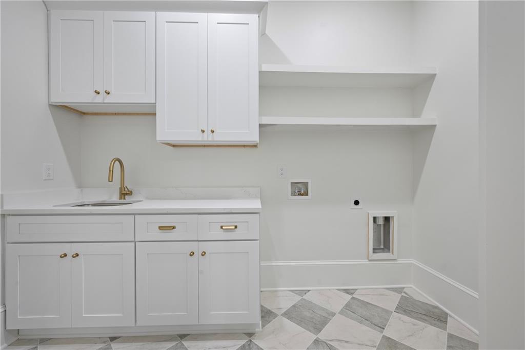 3287 Hall Road Dacula, GA 30019 - Photo 30 of 74 a kitchen with white cabinets and a sink