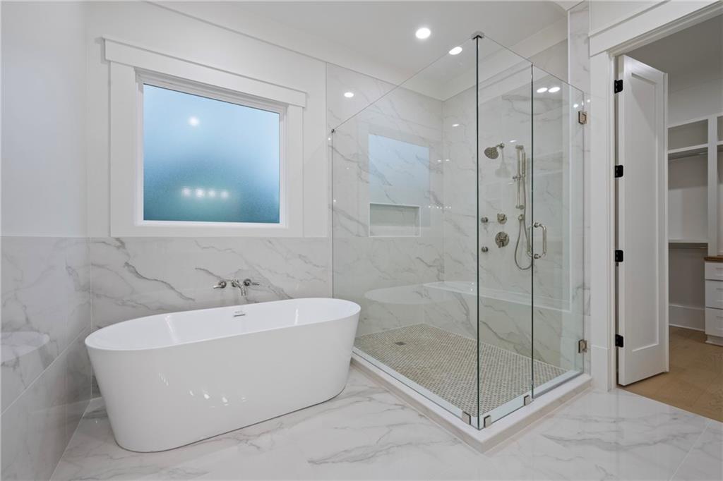 3287 Hall Road Dacula, GA 30019 - Photo 34 of 74 a bathroom with a bathtub and shower