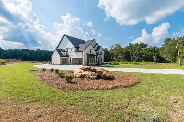 a house view with swimming pool and trees in the background
