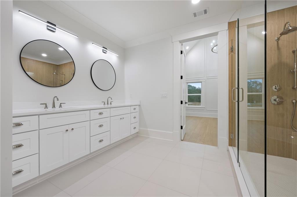 3287 Hall Road Dacula, GA 30019 - Photo 44 of 74 a spacious bathroom with a double vanity sink mirror and shower