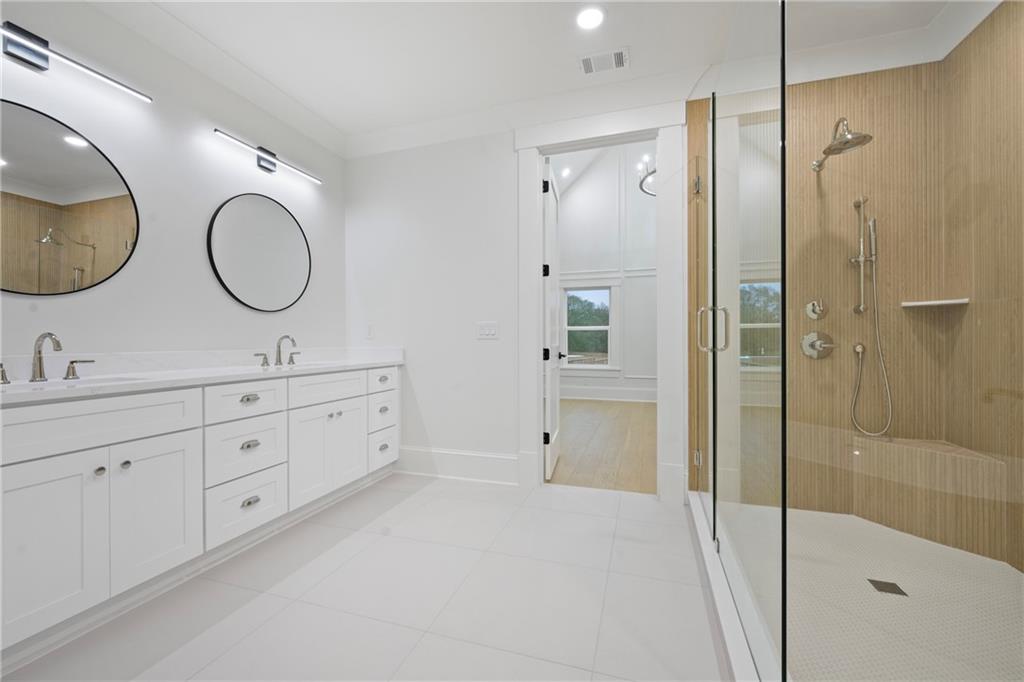 3287 Hall Road Dacula, GA 30019 - Photo 47 of 74 a spacious bathroom with a double vanity sink mirror and shower