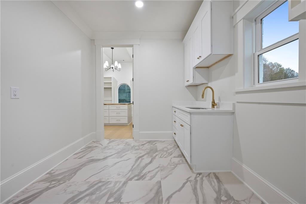 3287 Hall Road Dacula, GA 30019 - Photo 48 of 74 a kitchen with a sink cabinets and wooden floor