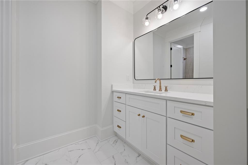 3287 Hall Road Dacula, GA 30019 - Photo 56 of 74 a bathroom with a sink and a mirror