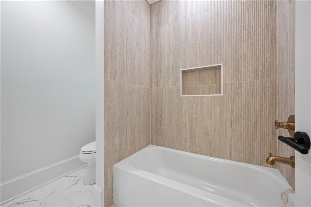 3287 Hall Road Dacula, GA 30019 - Photo 57 of 74 a bathroom with a white bath tub and a sink