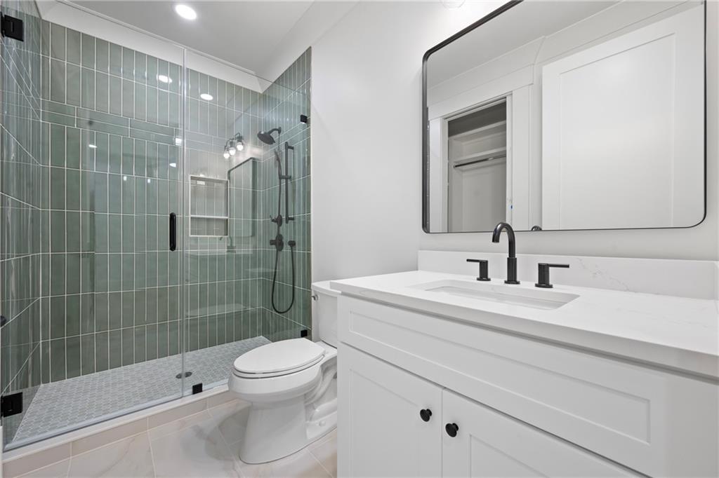 3287 Hall Road Dacula, GA 30019 - Photo 59 of 74 a bathroom with a sink a toilet and shower