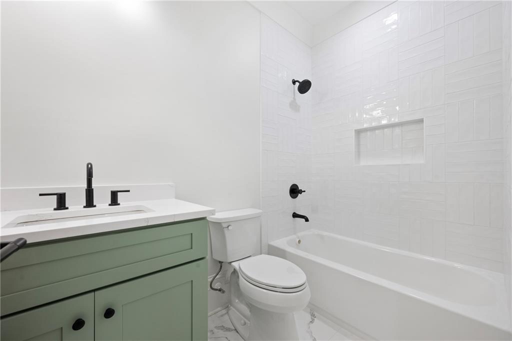 3287 Hall Road Dacula, GA 30019 - Photo 60 of 74 a bathroom with a sink a toilet and a bathtub