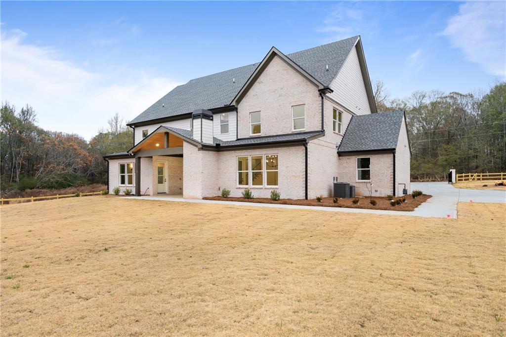 3287 Hall Road Dacula, GA 30019 - Photo 64 of 74 a front view of a house with a yard and garage