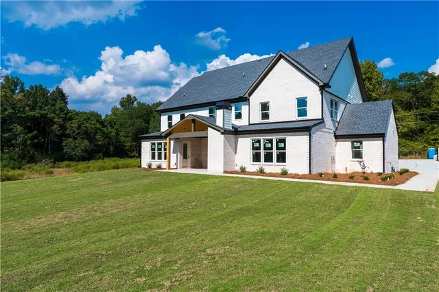 a front view of a house with a garden