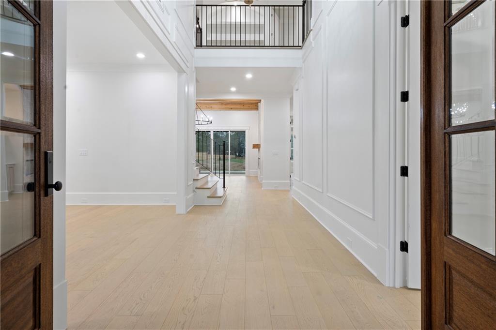 3287 Hall Road Dacula, GA 30019 - Photo 7 of 74 wooden floor in an empty room with a glass door