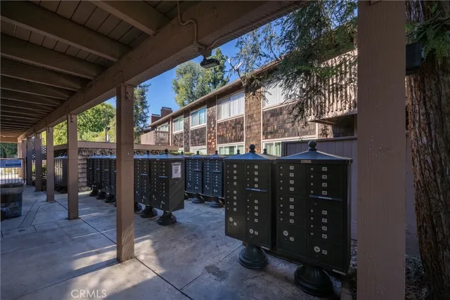 a view of a chair and table in the back yard of the house