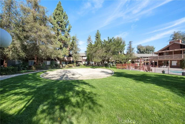 a backyard of a house with lots of green space and garden