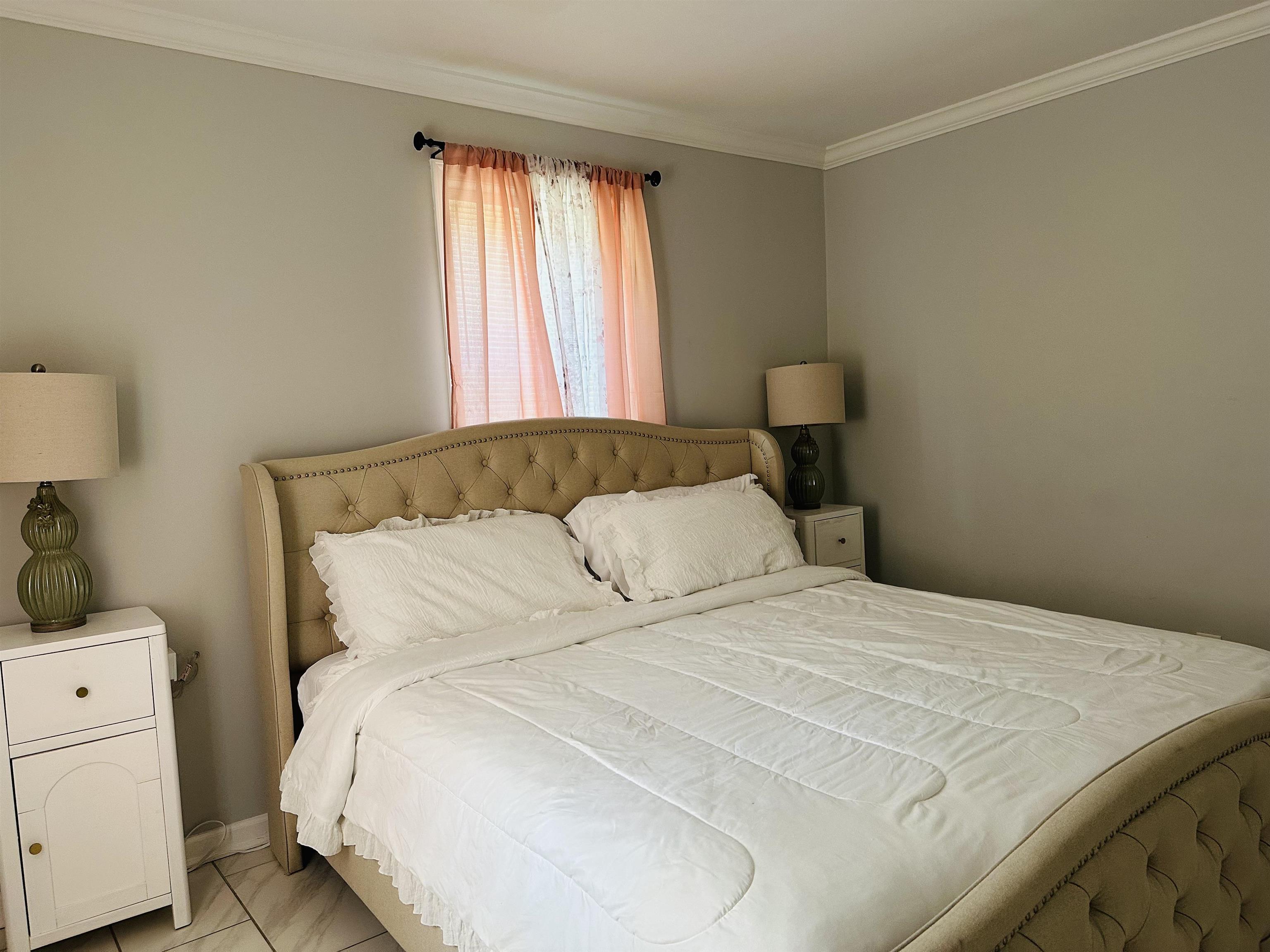 710 Vaughn Road Memphis, TN 38122 - Photo 14 of 18 Bedroom with crown molding and baseboards