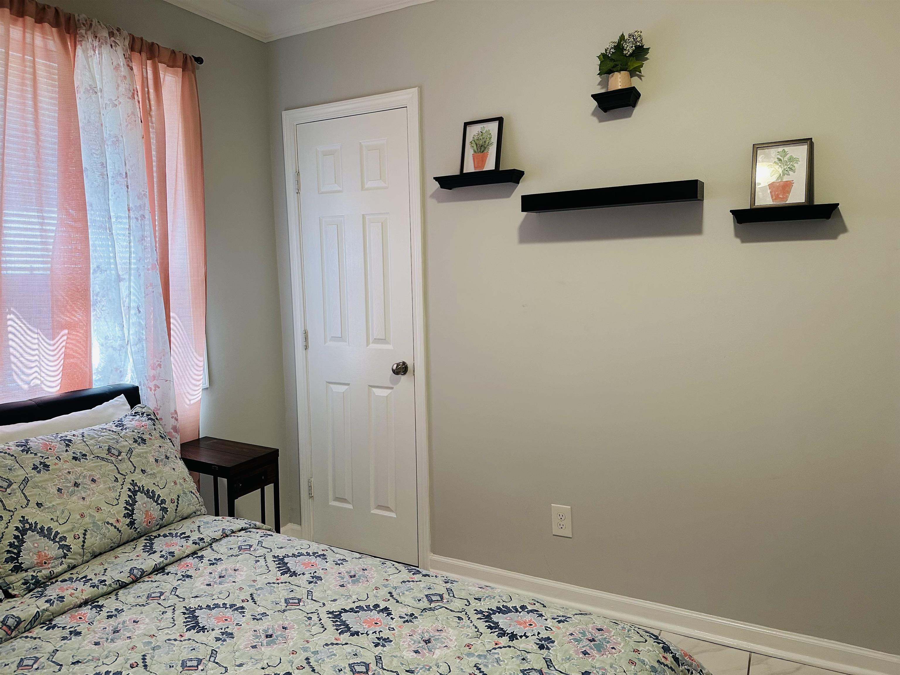 710 Vaughn Road Memphis, TN 38122 - Photo 16 of 18 Bedroom with baseboards and ornamental molding
