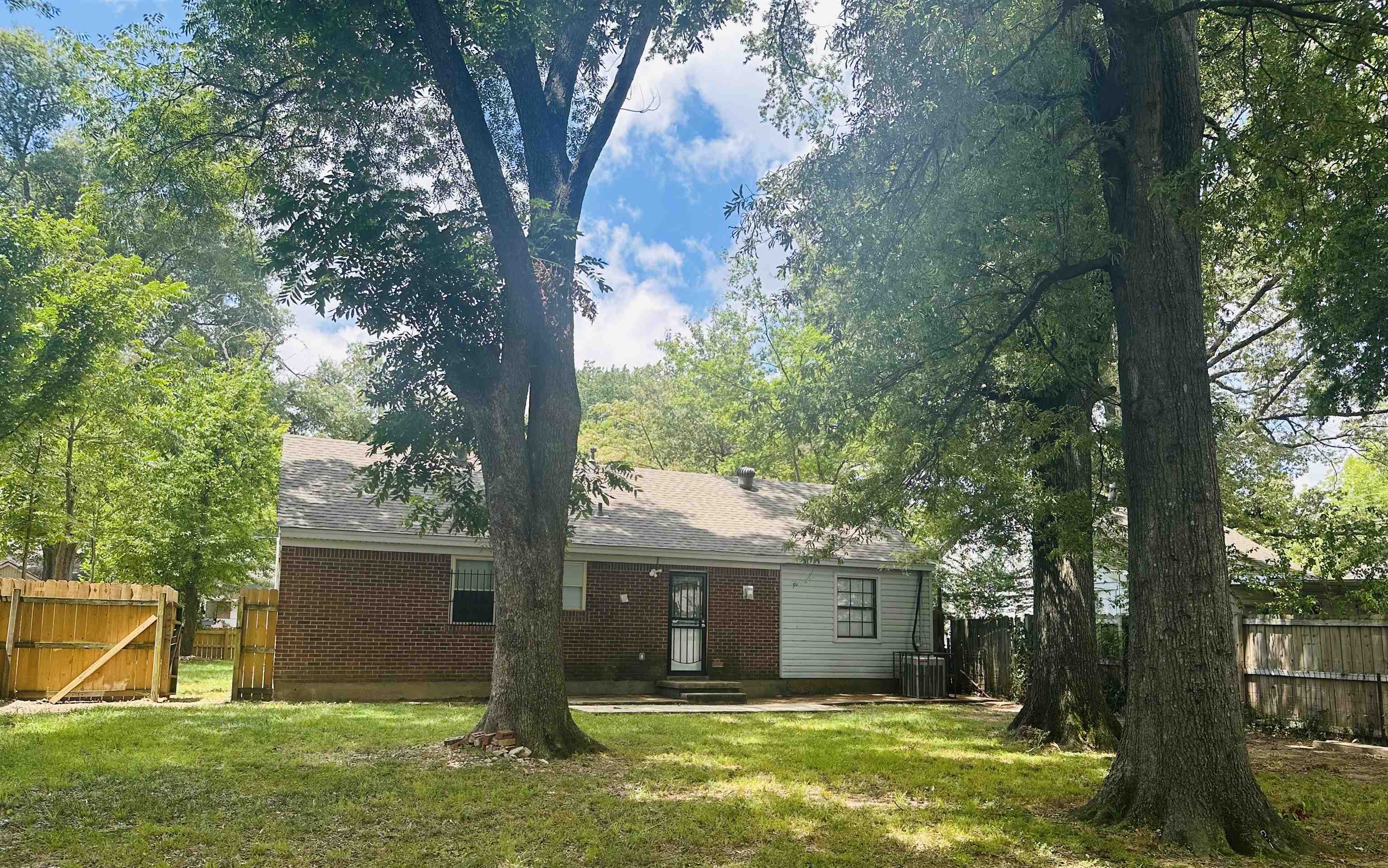 710 Vaughn Road Memphis, TN 38122 - Photo 8 of 18 Back of property featuring a gate, a shingled roof, entry steps, and a patio